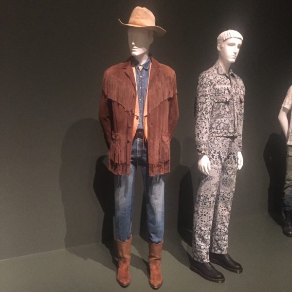 Ralph Lauren, an American designer born in 1939 in the Bronx (New York), designed the leather jacket & vest in this picture. The jeans and shirt are both made of denim. These were all part of a collection that dates to 1979.